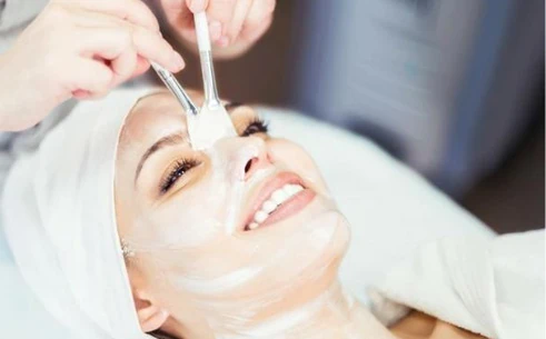 a woman getting a facial mask